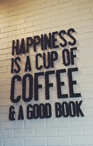 Display saying: Happiness is a cup of coffee and a good book